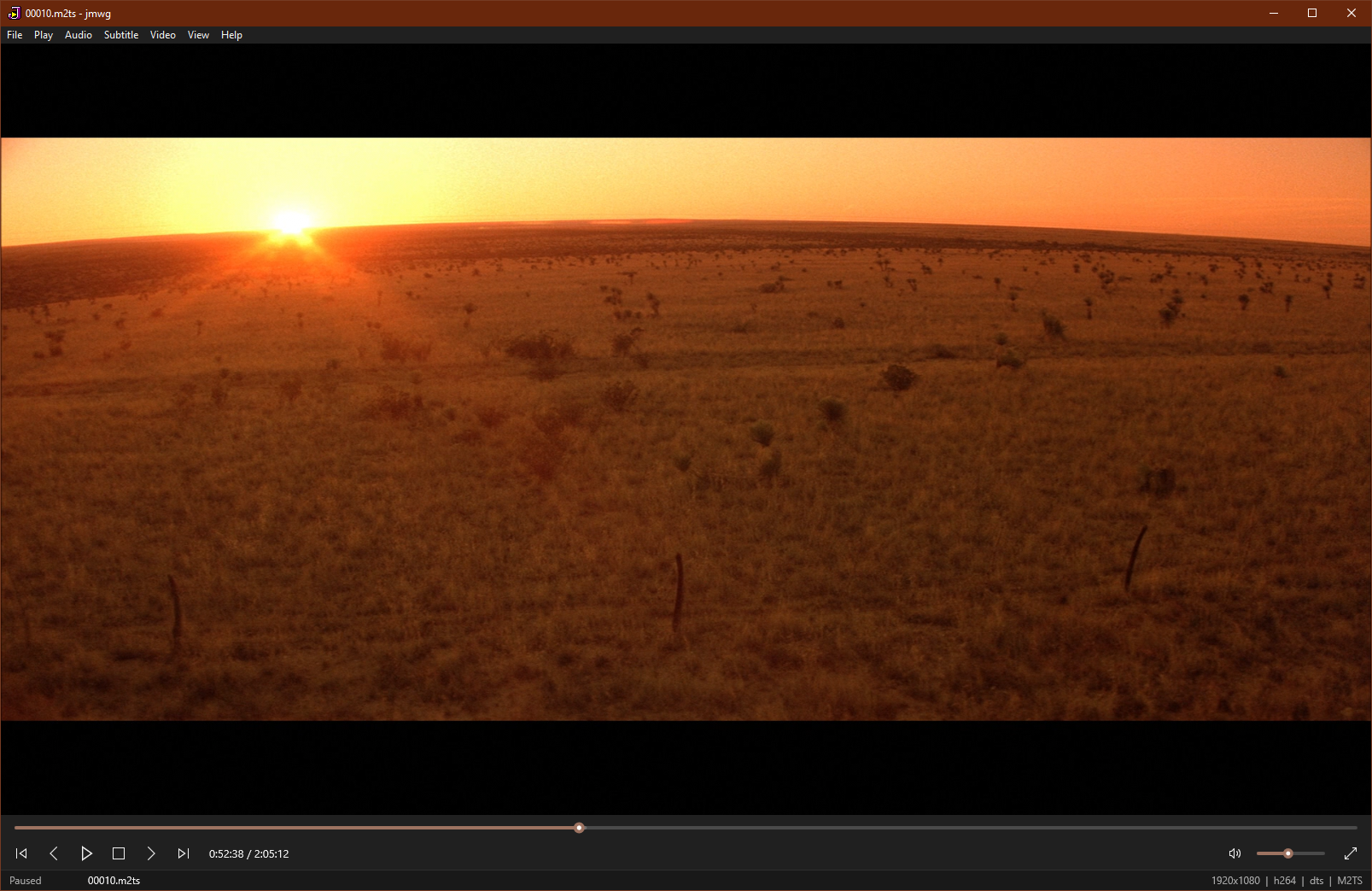Screenshot of jmwg: an mpv video frame beneath a Media Player Classic-style Win32 menu bar and playback controls.
