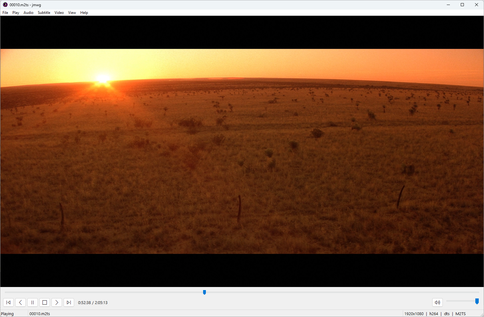 Screenshot of jmwg: an mpv video frame beneath a Media Player Classic-style Win32 menu bar and playback controls.